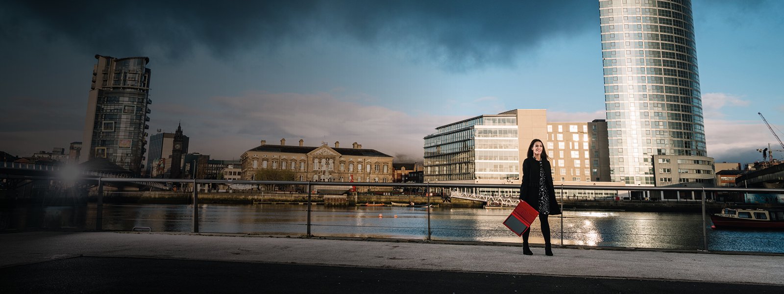 Female Student with red laptop in stunning Belfast location