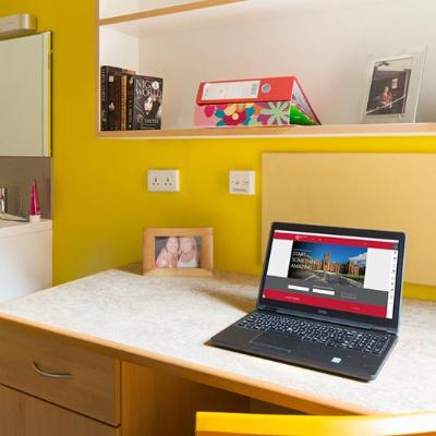 work area in a students room with a laptop sitting on it