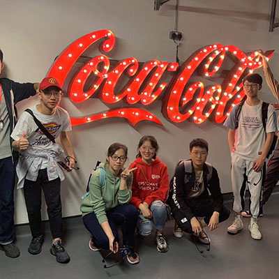 Students with Coca-Cola sign
