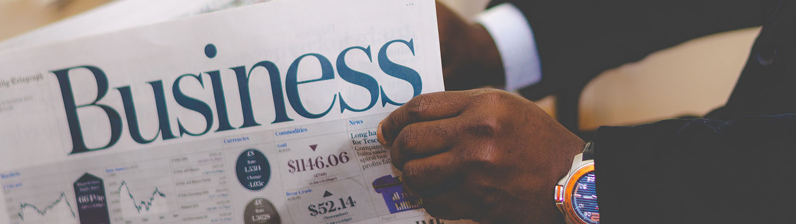 Man reading the Business papers