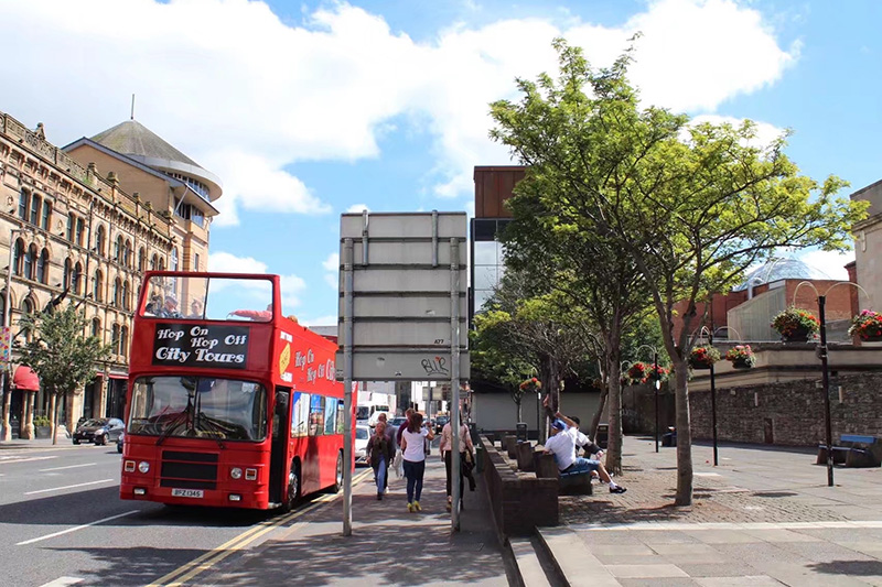 Helen getting an opn top sight-seeing bus in Belfast