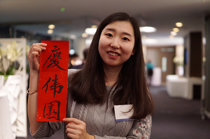 Yuan at Chinese New Year holding a banner