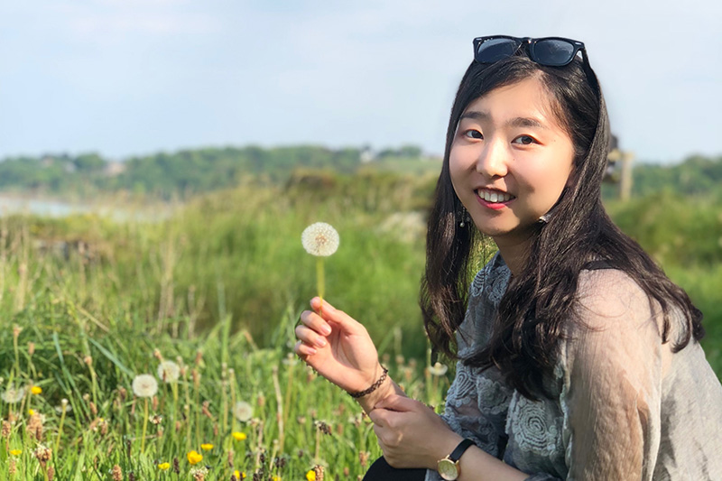 Yuan in Bangor with a dandelion clock