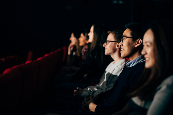 Image shows a group of students watching a film in Queen's Film Theatre