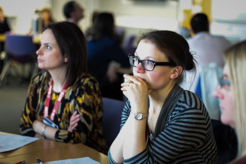 Woman listening to speaker and concentrating