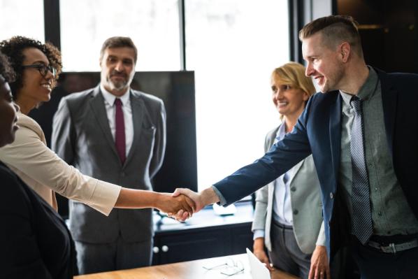 People Smiling and Shaking Hands