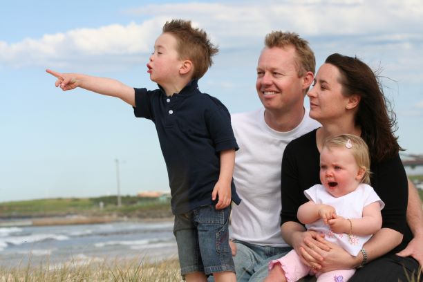 Young boy pointing family of 4