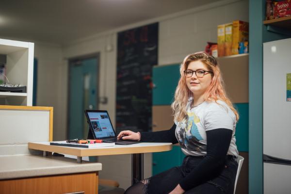 A student sitting at her laptop.