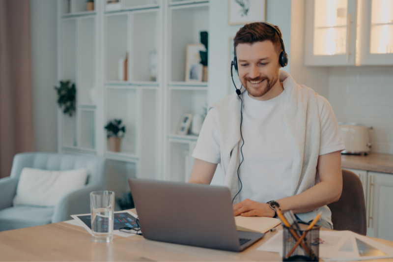 male intern sitting at laptop working from home