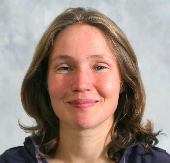 Image of Zoe Robinson, a Caucasian female with brown hair down to her shoulders facing at the camera with slightly smiling