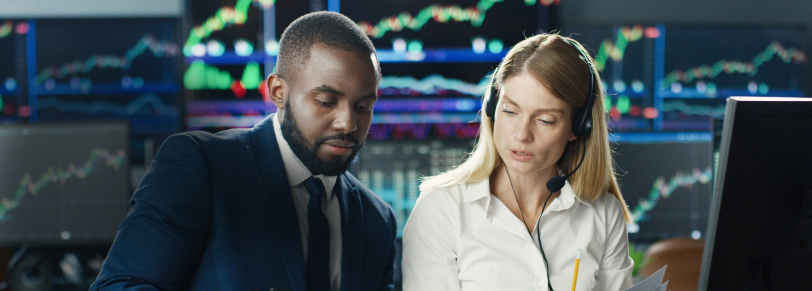 male and female working at stock exchange