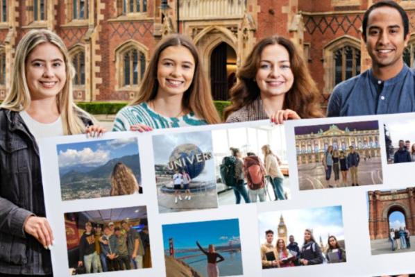 students standing outside holding a banner with travel images