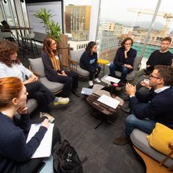 students in a working group sitting around a table