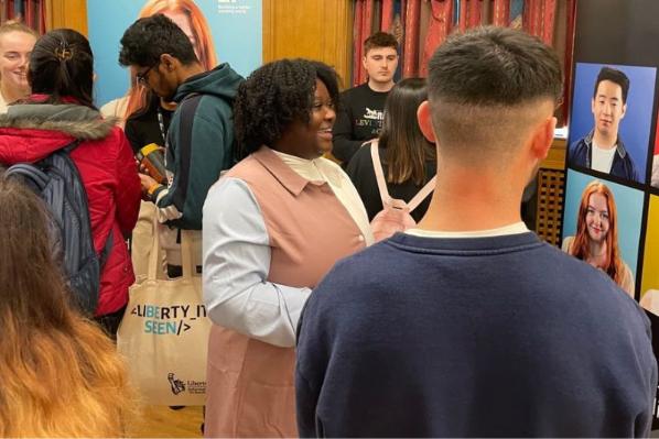 students at an employer event chatting to employers at stands