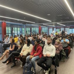 students sitting at an event in One Elmwood