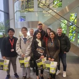 students standing in a group inside an employers premises on work shadowing week