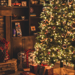 Image shows a Christmas tree with presents underneath.