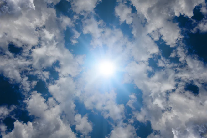 Image shows the sun shining through the clouds.