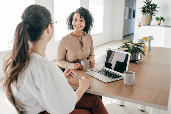 Image shows two staff members having a meeting.