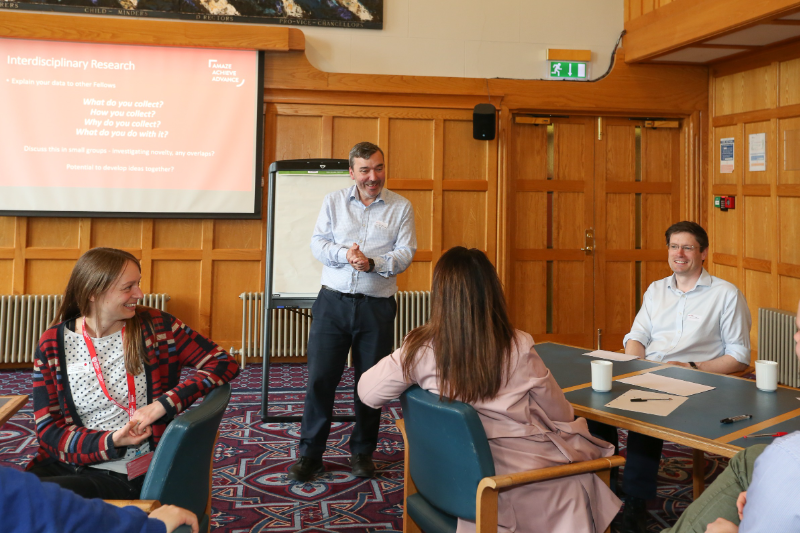 Image shows Research Development Manager Paul Monahan conversing with Fellows at the networking event