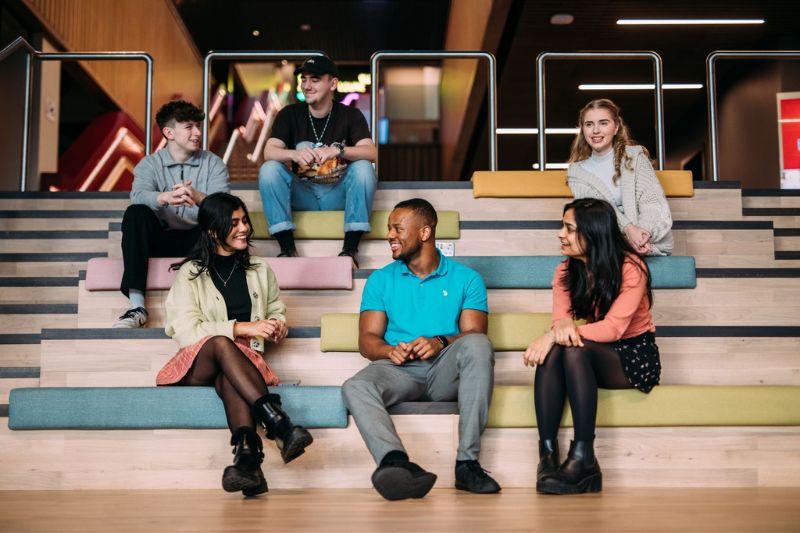 students sitting in a group on the staircase in One Elmwood