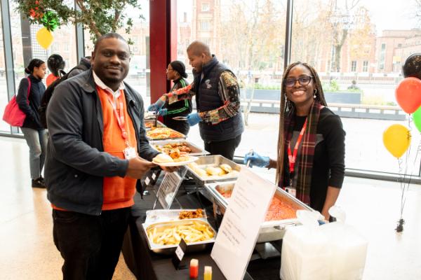 Image shows two staff members at the Black History Month event in One Elmwood, 2022