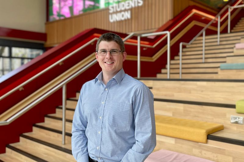 Image of Phil Wren standing at staircase