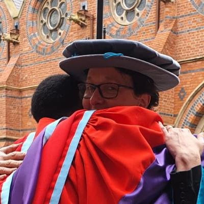 An informal campus pic of Dr Belluigi and Dr Queiroz embracing on the latter’s graduation day that had been delayed due to Covid restrictions.