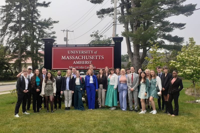 Queen's students on the Boston programme  standing at a sign