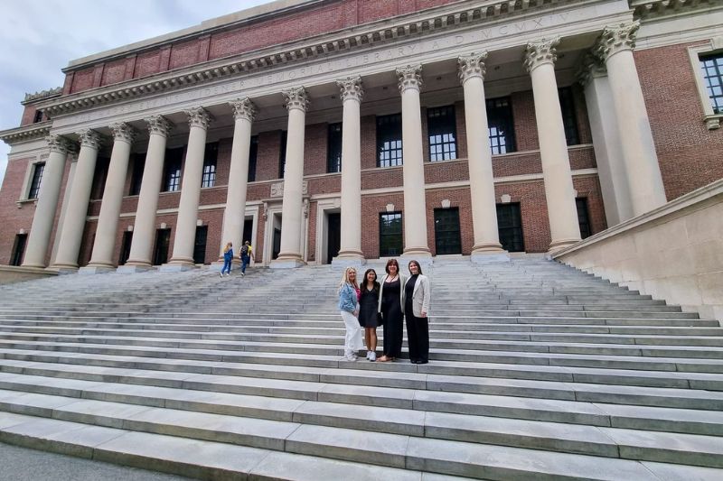 members of Boston programme standing on steps of a building