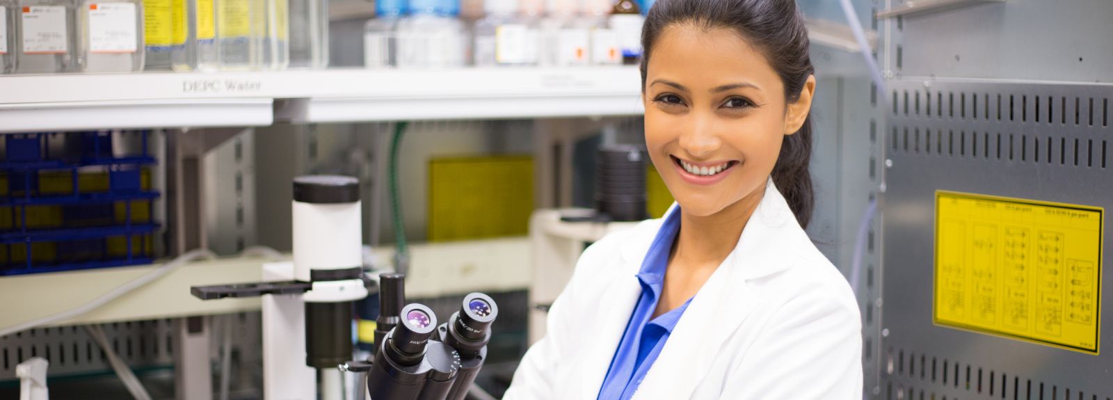 female scientist in lab in a white coat
