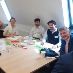 students sitting at a table with employer