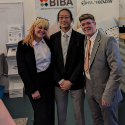 three students standing together at a company premises in Boston