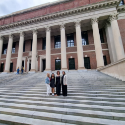 students standing with employer on steps of a building in Boston