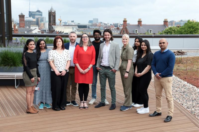 students standing on roof terrace with employers