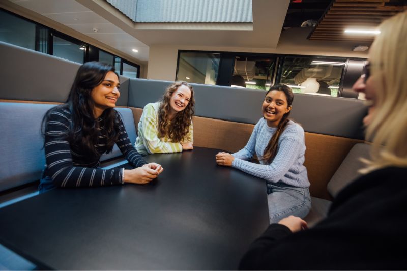 student sitting around a table chatting