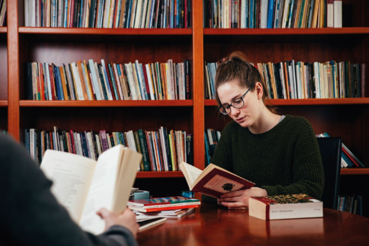 female student sitting in a library