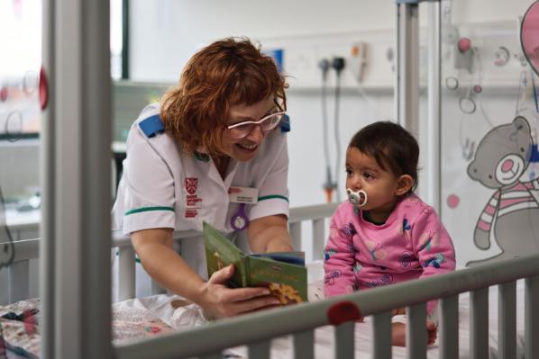 Nursing student with female baby in hospital style setting