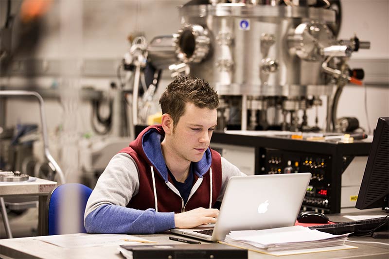 student working on laptop in engineering lab