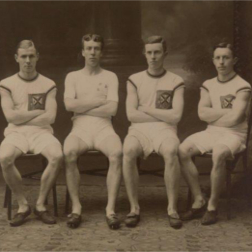 Four men from the Queen's University of Belfast Athletic Club in 1912 sitting in chairs