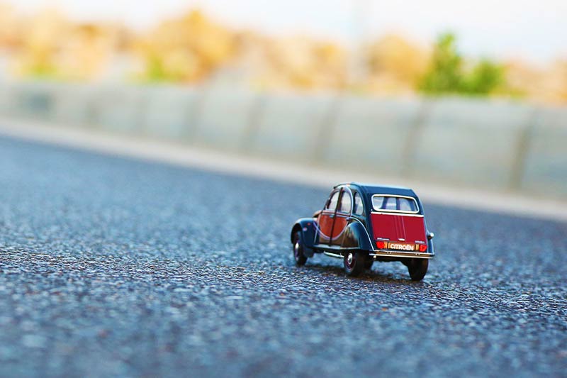 a red toy car on a road