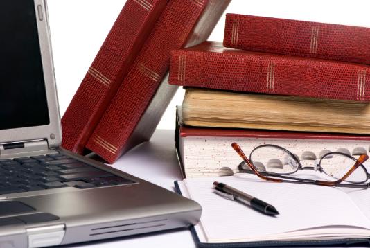 Library books, laptop and notebook