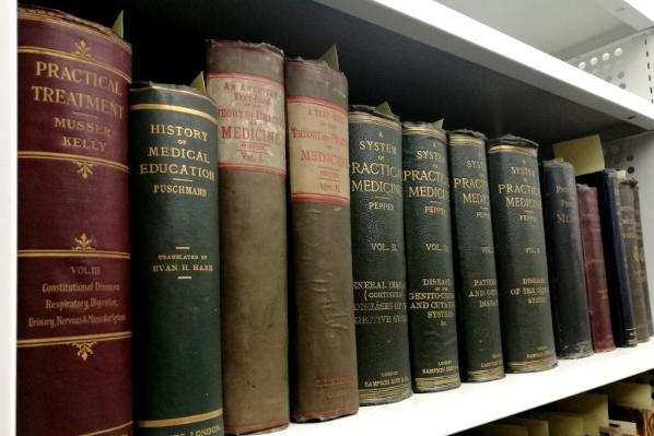 A shelf of books from the Belfast Medical Library in the Special Collections store. 