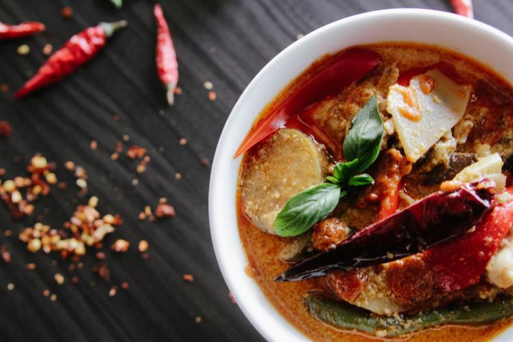 A bowl with cooked food and ingredients