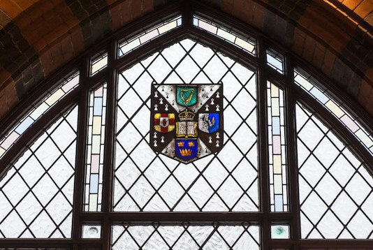 Window with coloured glass QUB crest