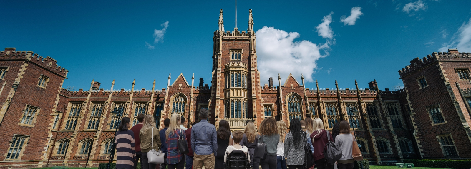students at the front of Queen's University standing together