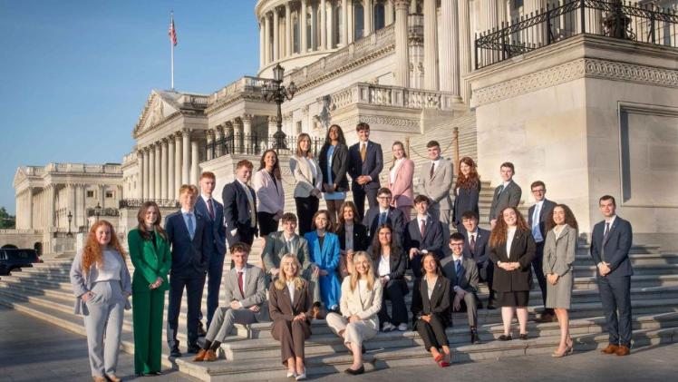 students standing in front of a US landmark