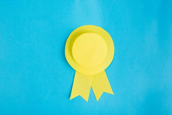 Blue background with a yellow, paper award badge