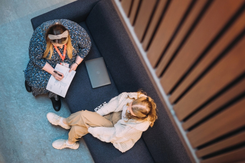 Student and staff sitting talking from an overhead viewpoint