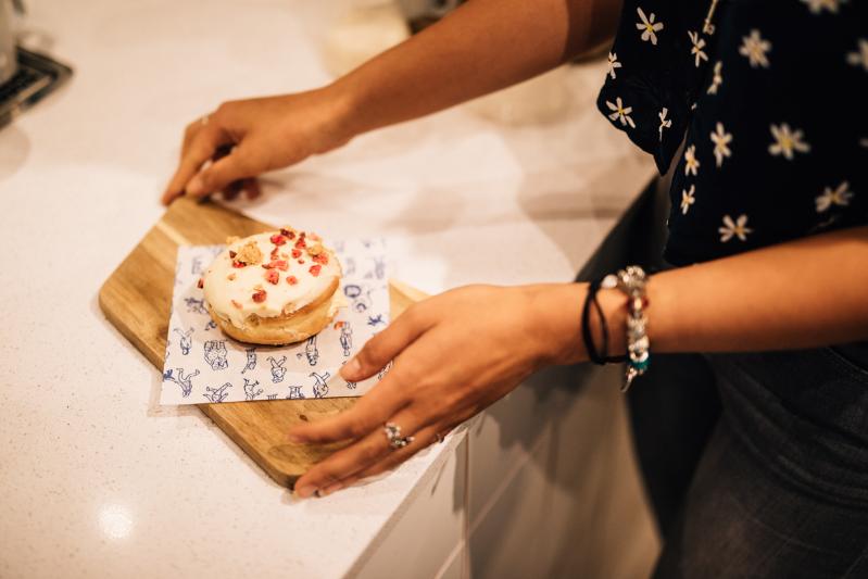 Image of a student lifting a doughnut